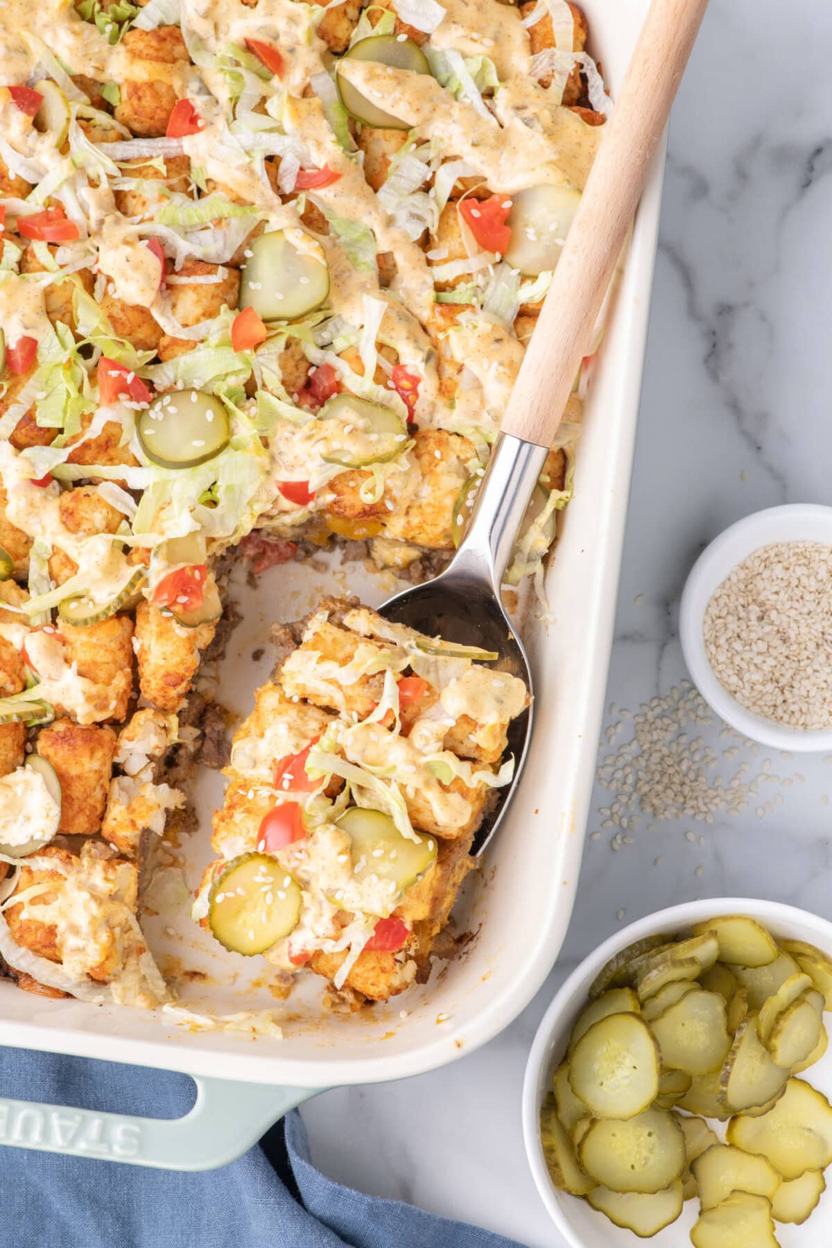 Spoonful of Big Mac Casserole resting in a casserole dish