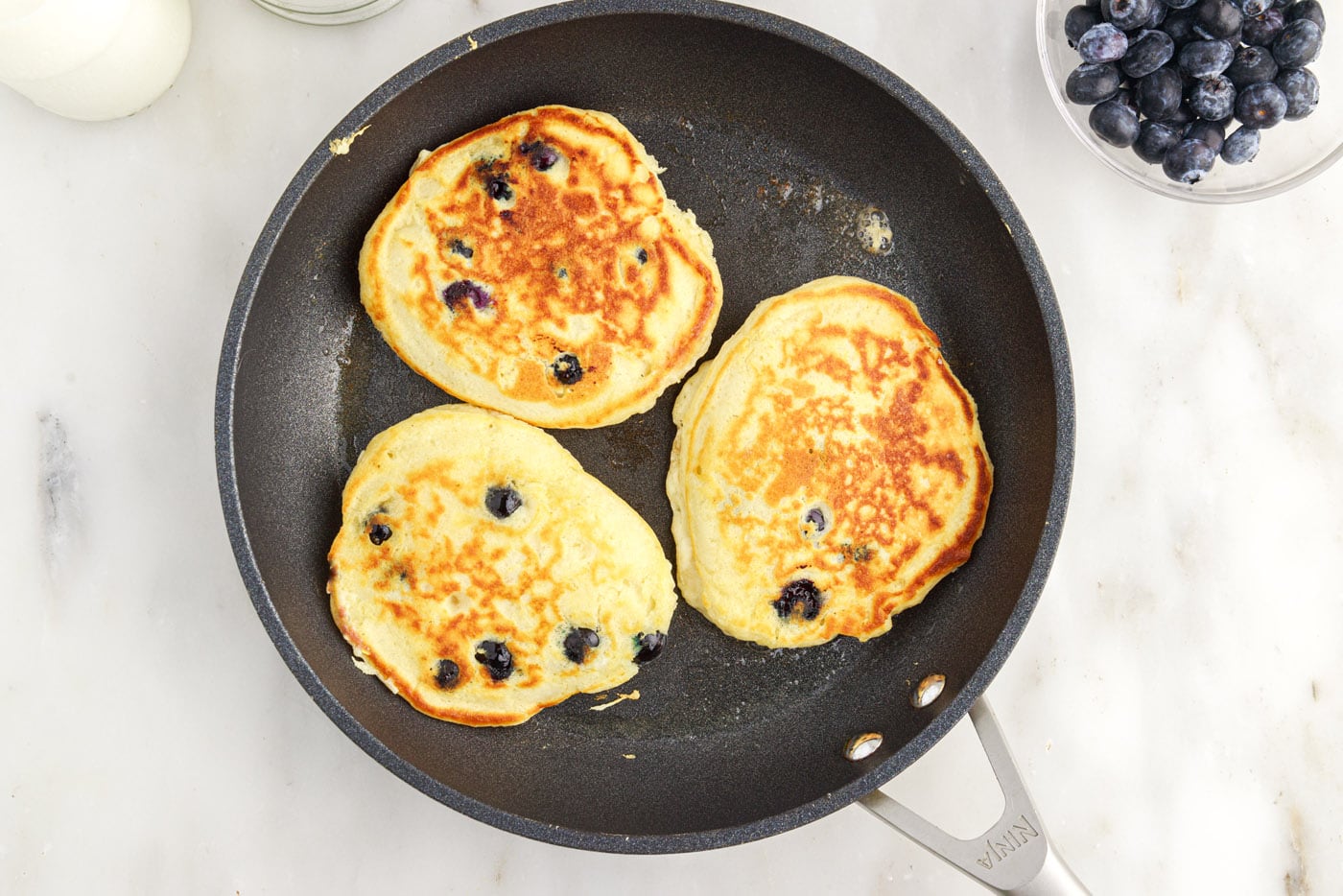cooked blueberry pancakes in a skillet