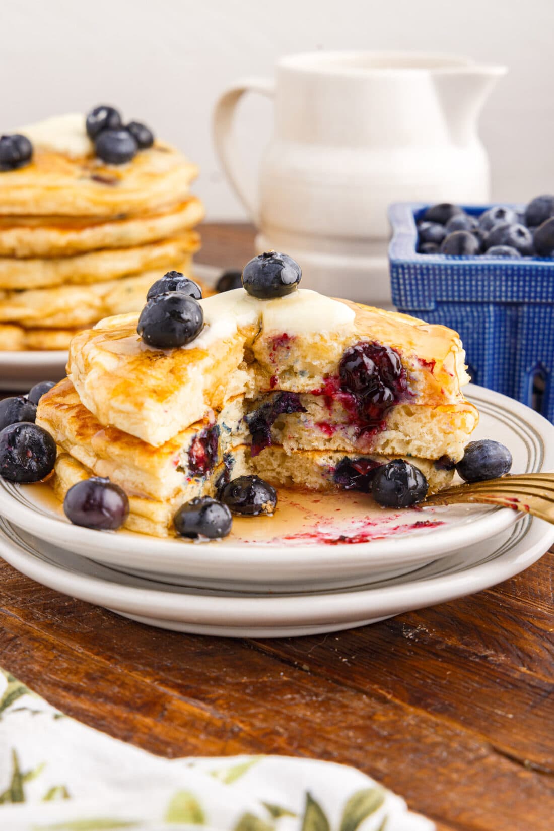 Stack of Blueberry Pancakes on a plate with a bite removed