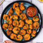 Breaded Shrimp on a plate with a bowl of cocktail sauce