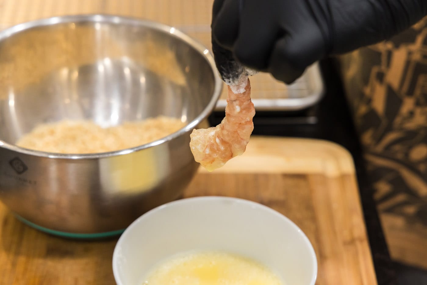 dipping flour coated shrimp in egg