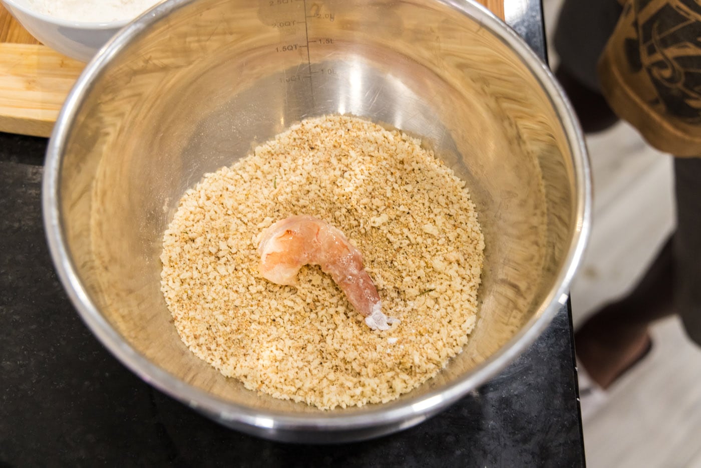 coating dredged shrimp in bread crumb mixture