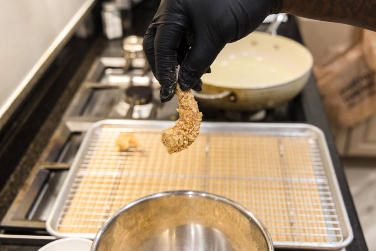 hand holding breaded shrimp