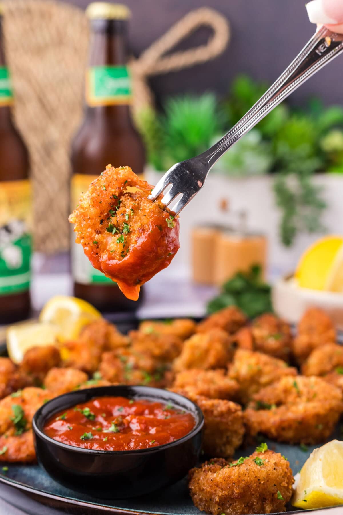 Breaded Shrimp dipped in cocktail sauce on a fork