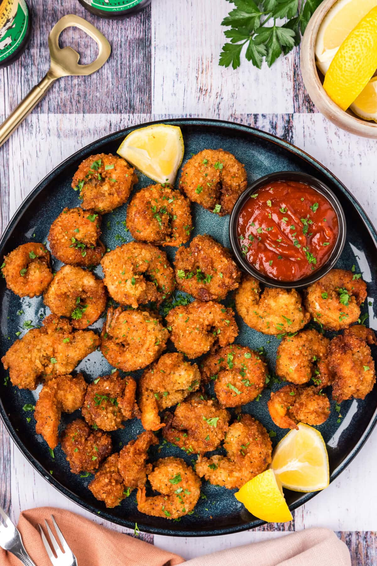 Breaded Shrimp on a plate with lemon wedges