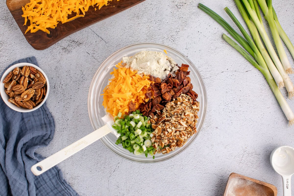 cheddar cheese, pecans, bacon, green onions, and cream cheese mixture in a bowl