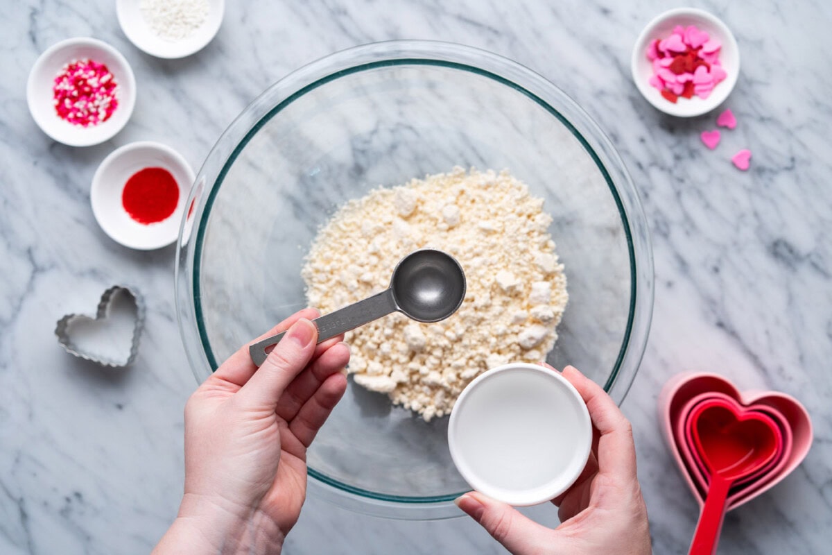 adding water to jiffy pie mix in bowl