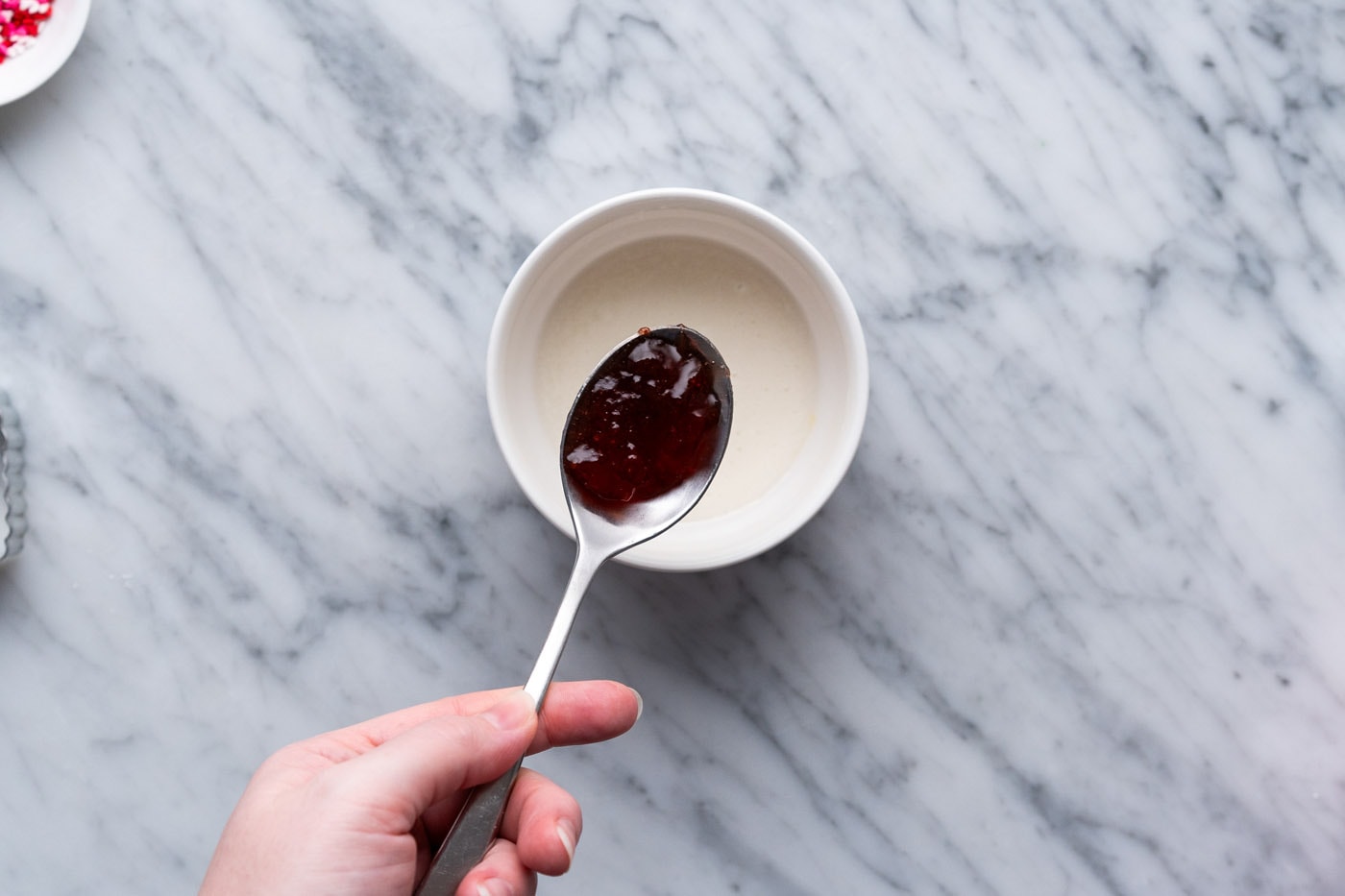 spoonful of strawberry jam over top of glaze