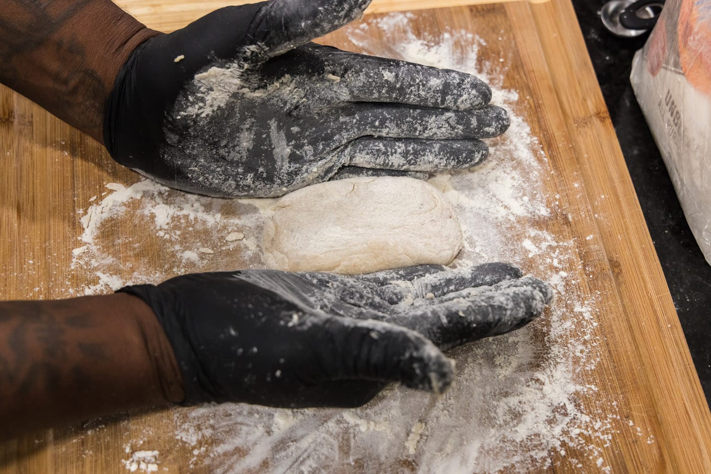 shaping fish cake dough with gloved hands