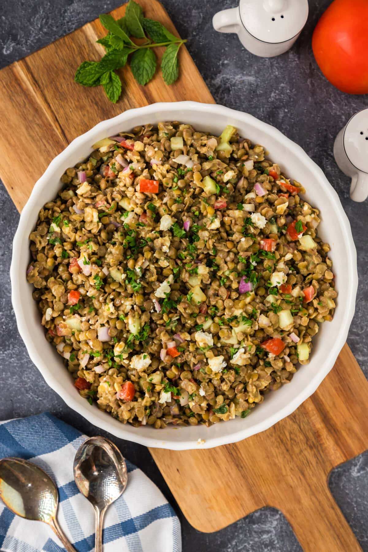 Lentil Salad in a bowl resting on a wooden platter