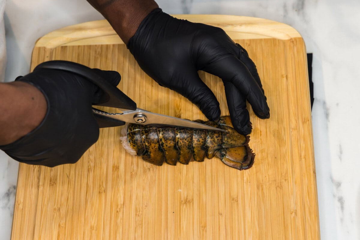 slicing lobster tail with kitchen shears