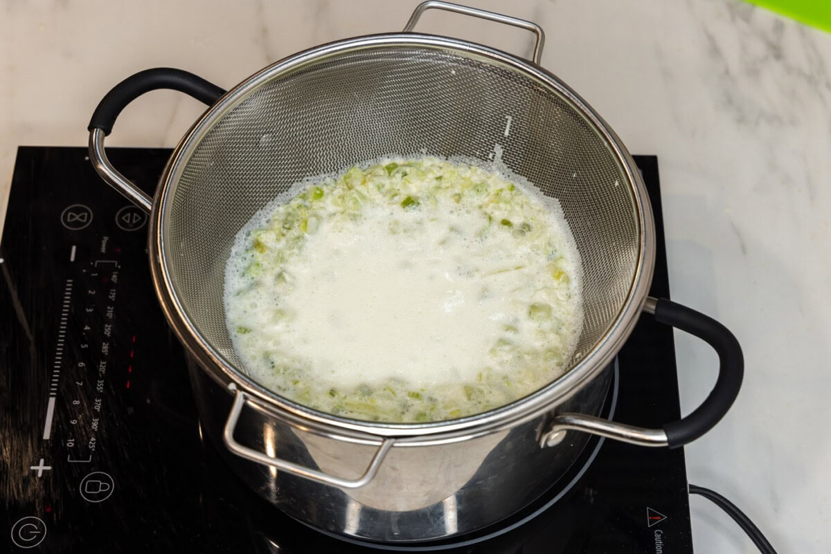 straining pasta sauce in a colander