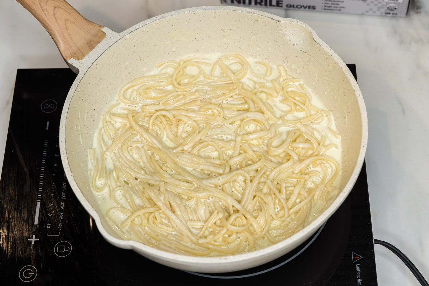 linguine noodles in skillet with lobster sauce