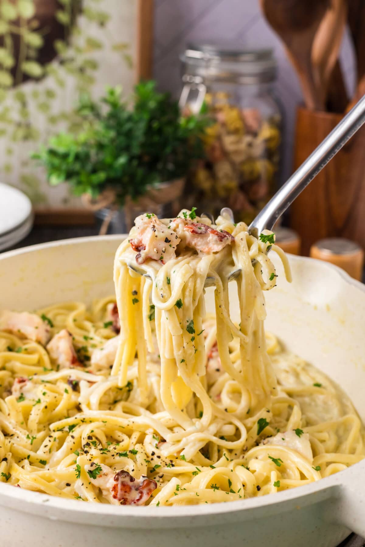 Spoonful of Lobster Pasta being lifted out of a skillet