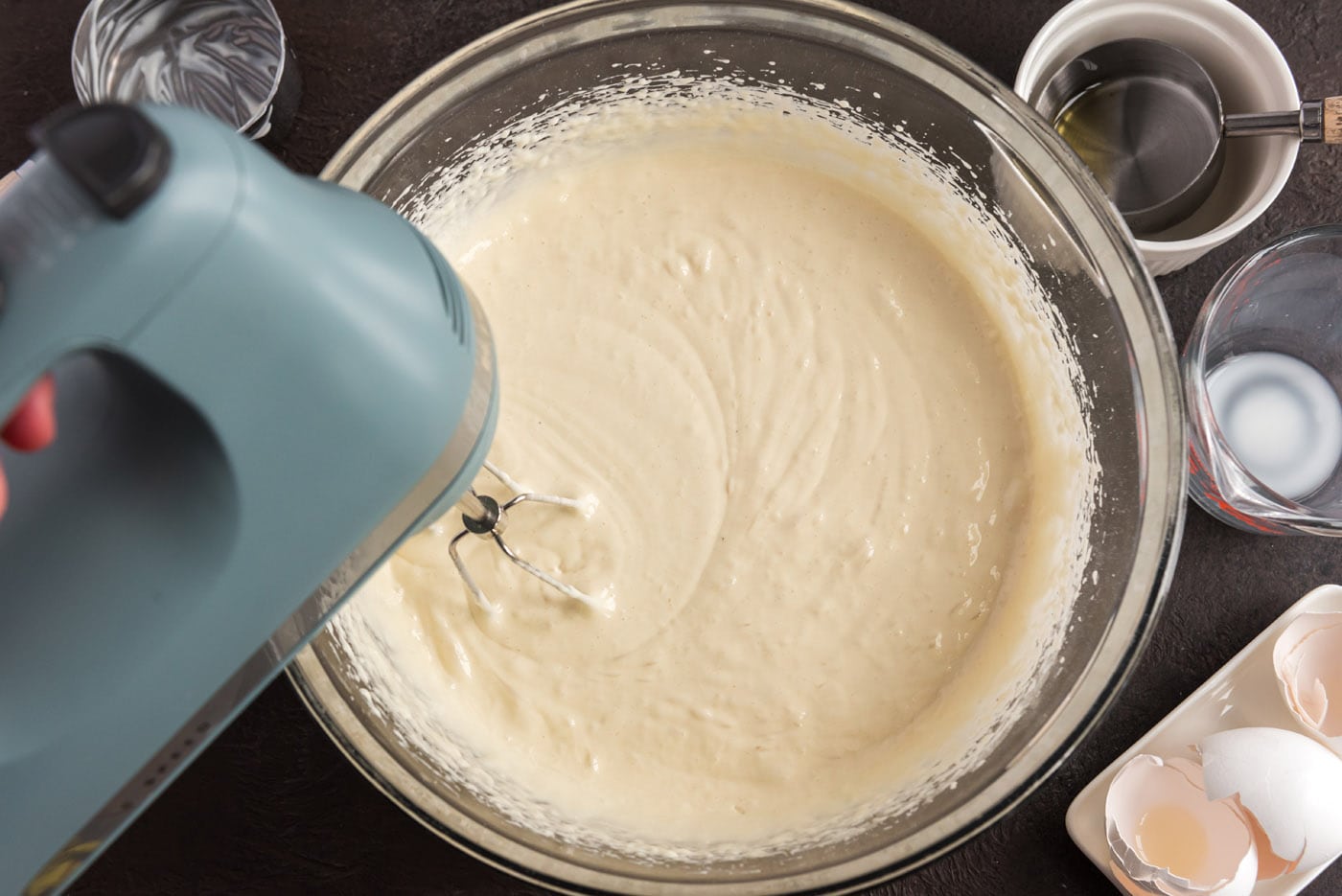 beating cake mix ingredients with a hand mixer