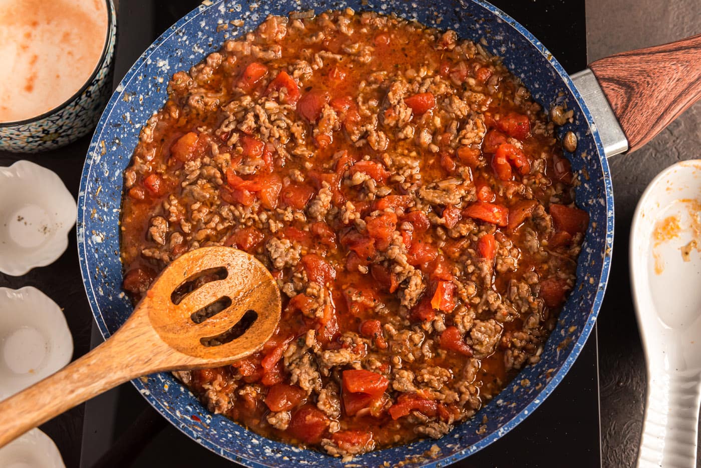ground sausage tomato sauce in a skillet