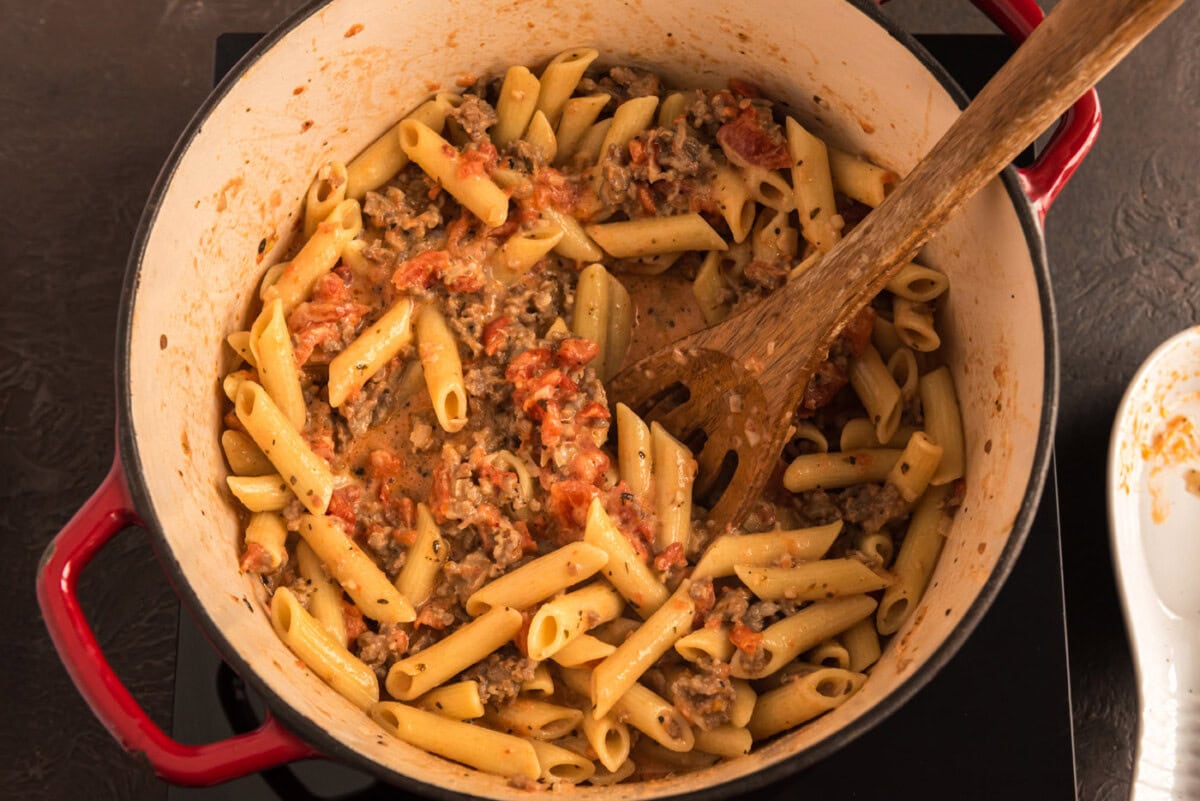 penne with tomato sage sausage sauce in a pot