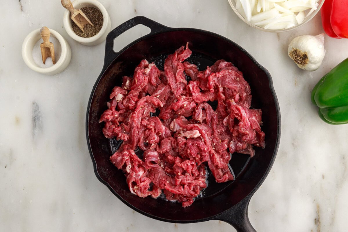 searing flank steak slices in a skllet