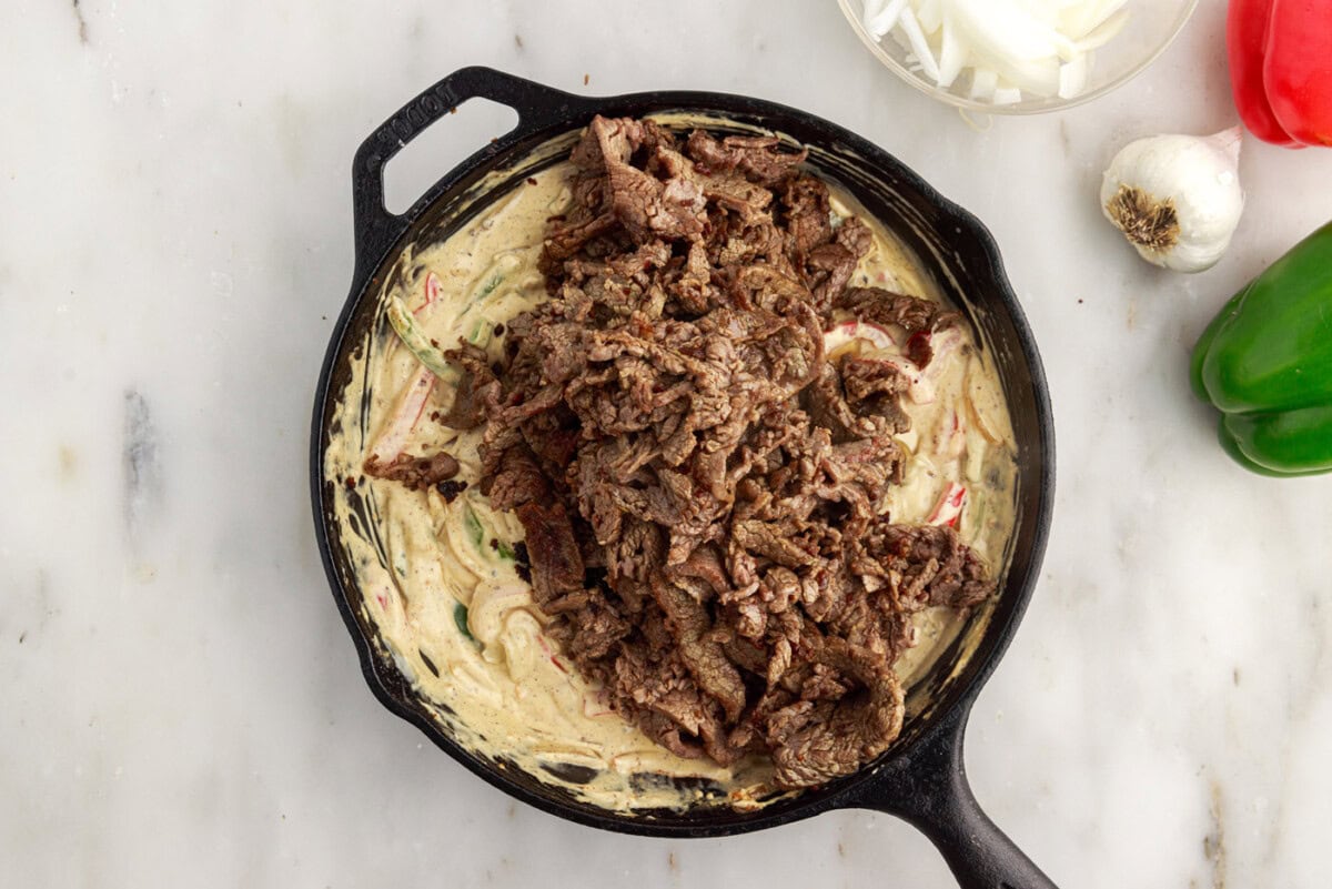 sliced flank steak added on top of cream cheese and veggie mixture