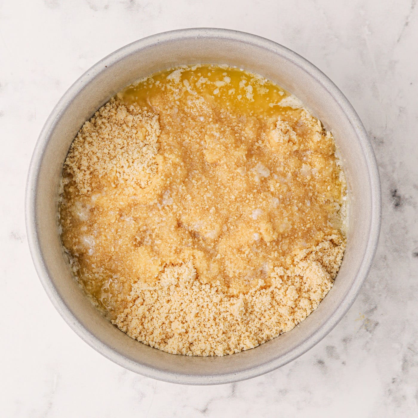 melted butter and crushed golden Oreos in a bowl