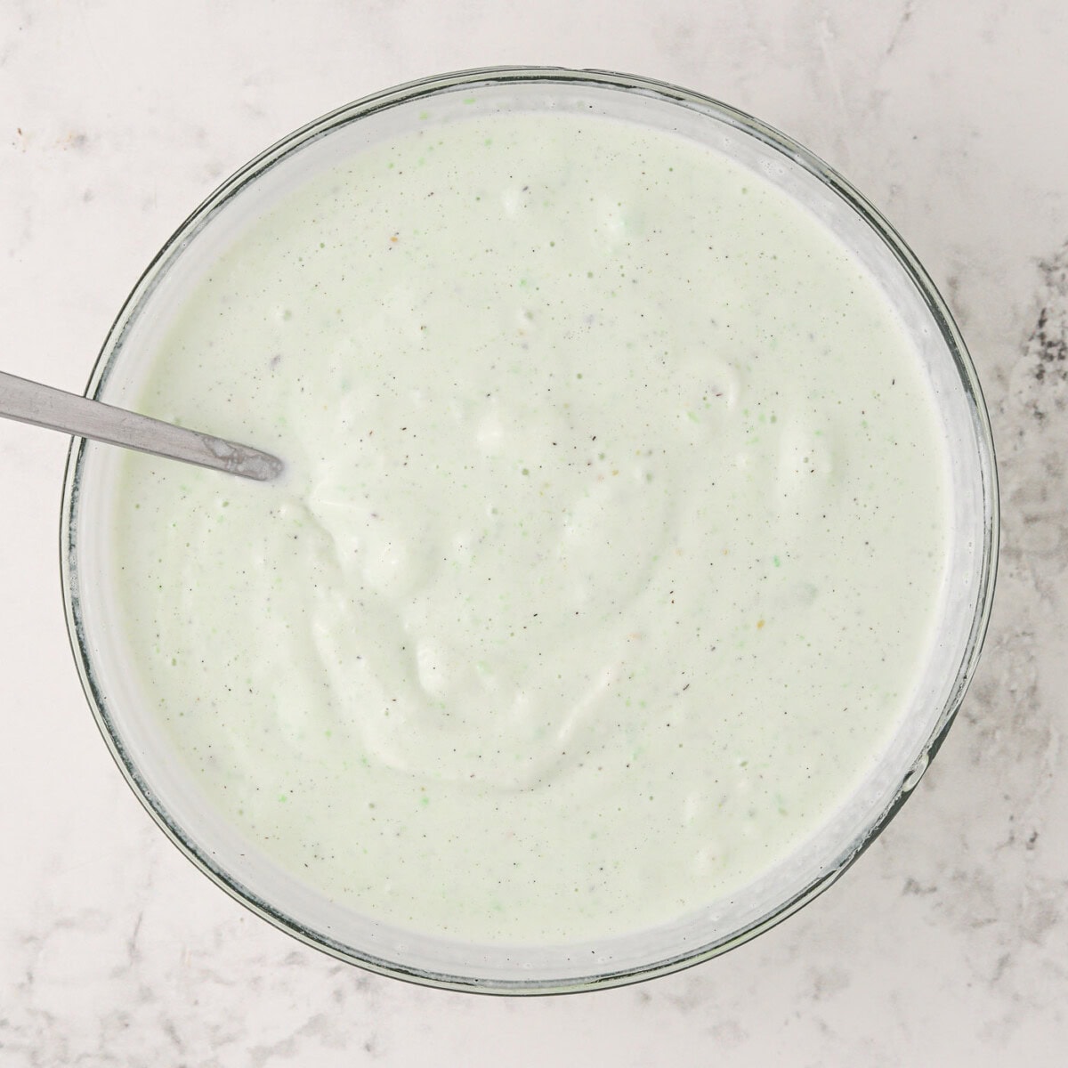 pistachio pudding mixed with vanilla ice cream in a bowl