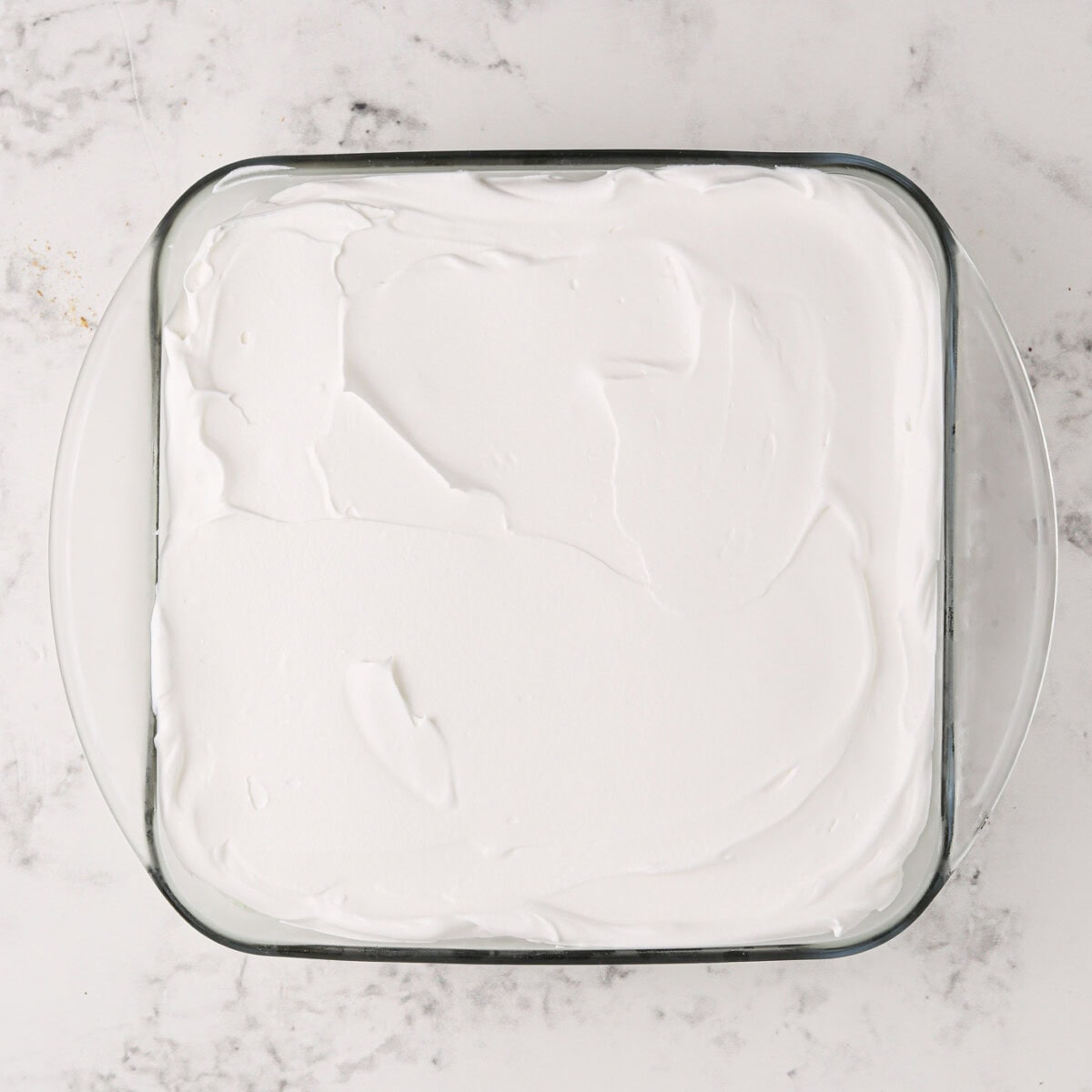 whipped topping overtop pistachio ice cream