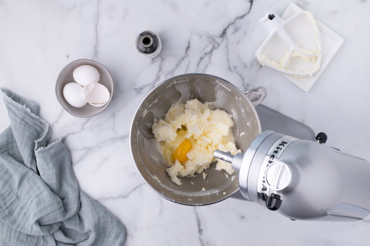beating eggs into butter and sugar mixture