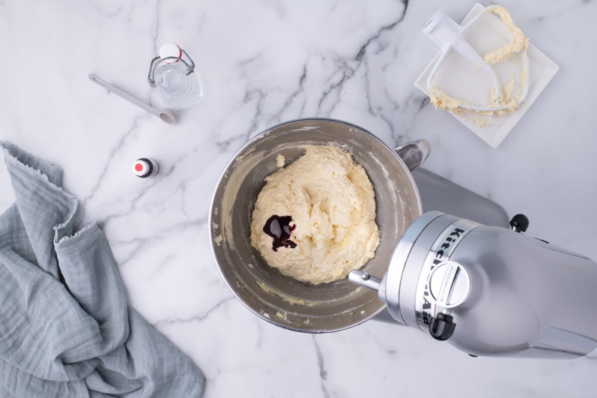 adding red food coloring and vinegar to red velvet cake ingredients