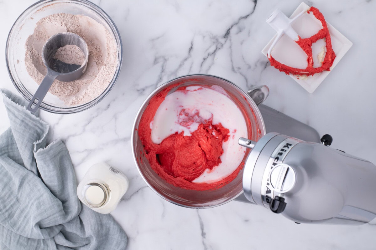 mixing buttermilk into red velvet cupcake batter