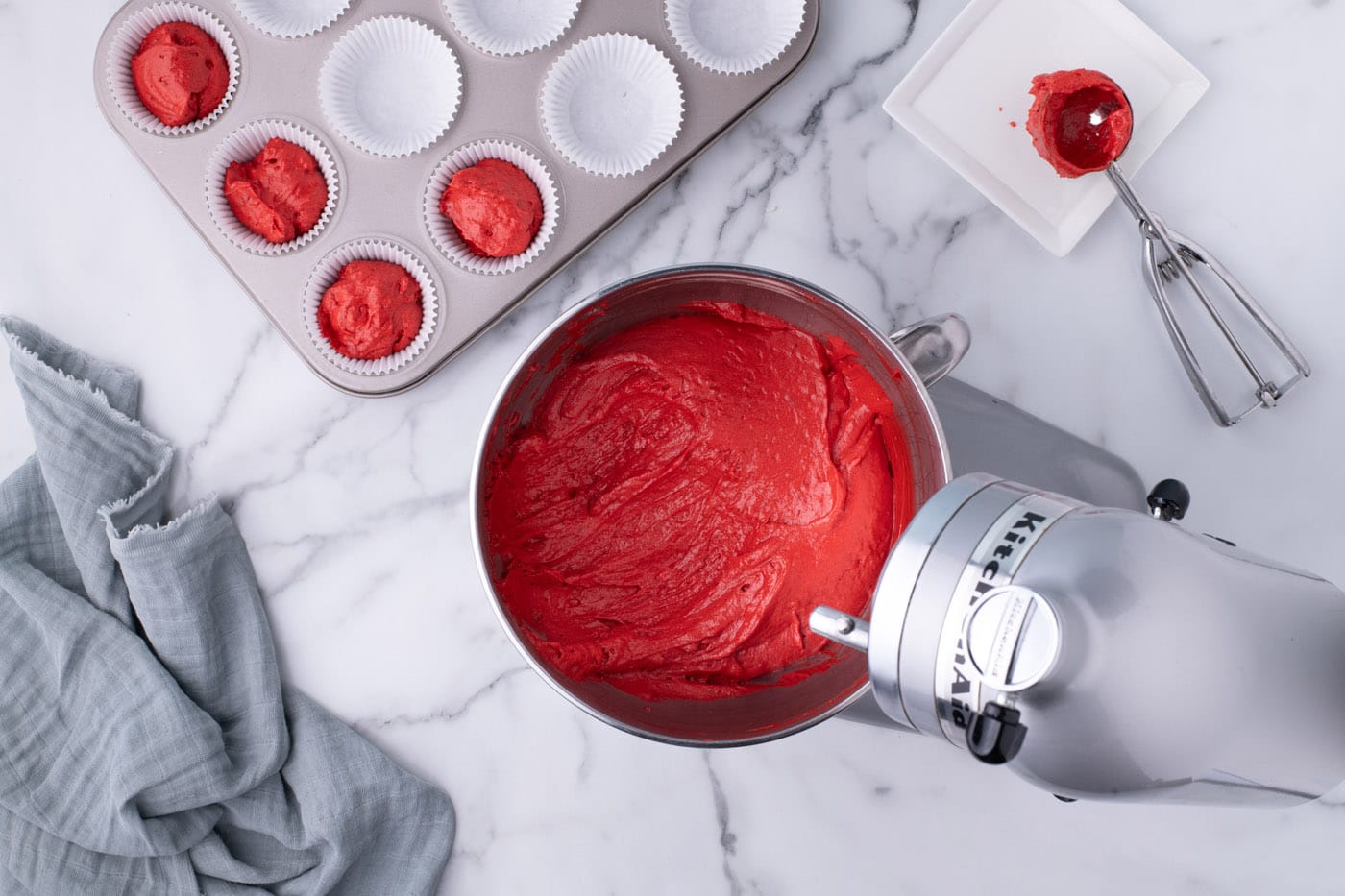 red velvet cupcake batter in a mixer bowl