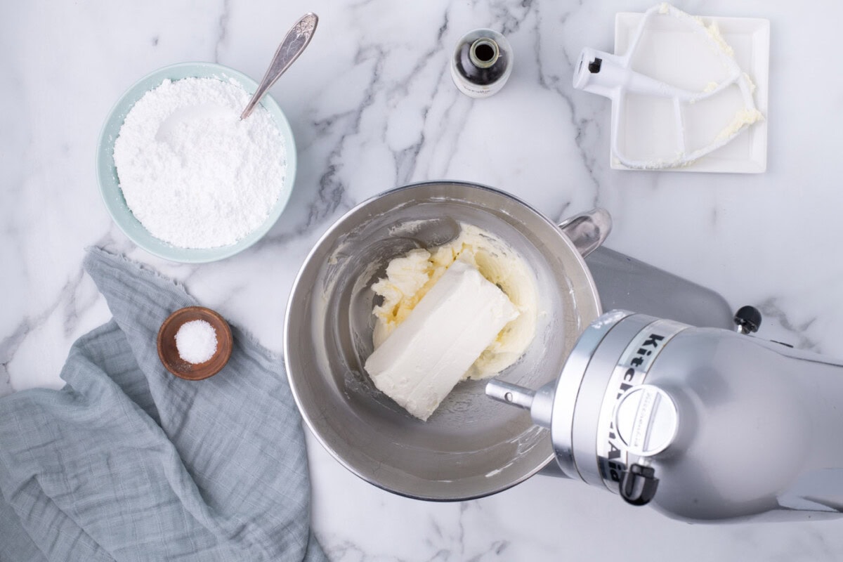 beating cream cheese with butter in a bowl
