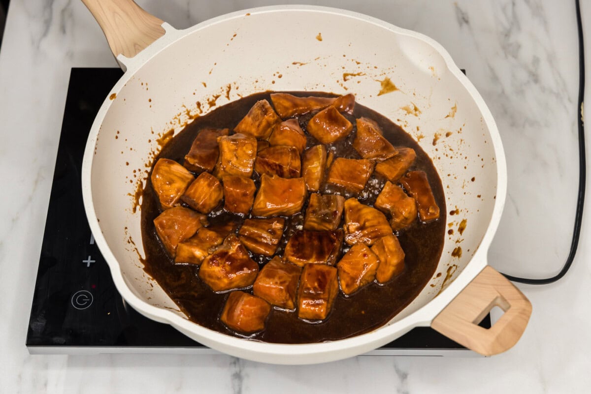 cooking salmon bites in marinde in a skillet
