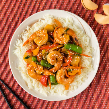 Shrimp Stir Fry over a bed of rice on a plate
