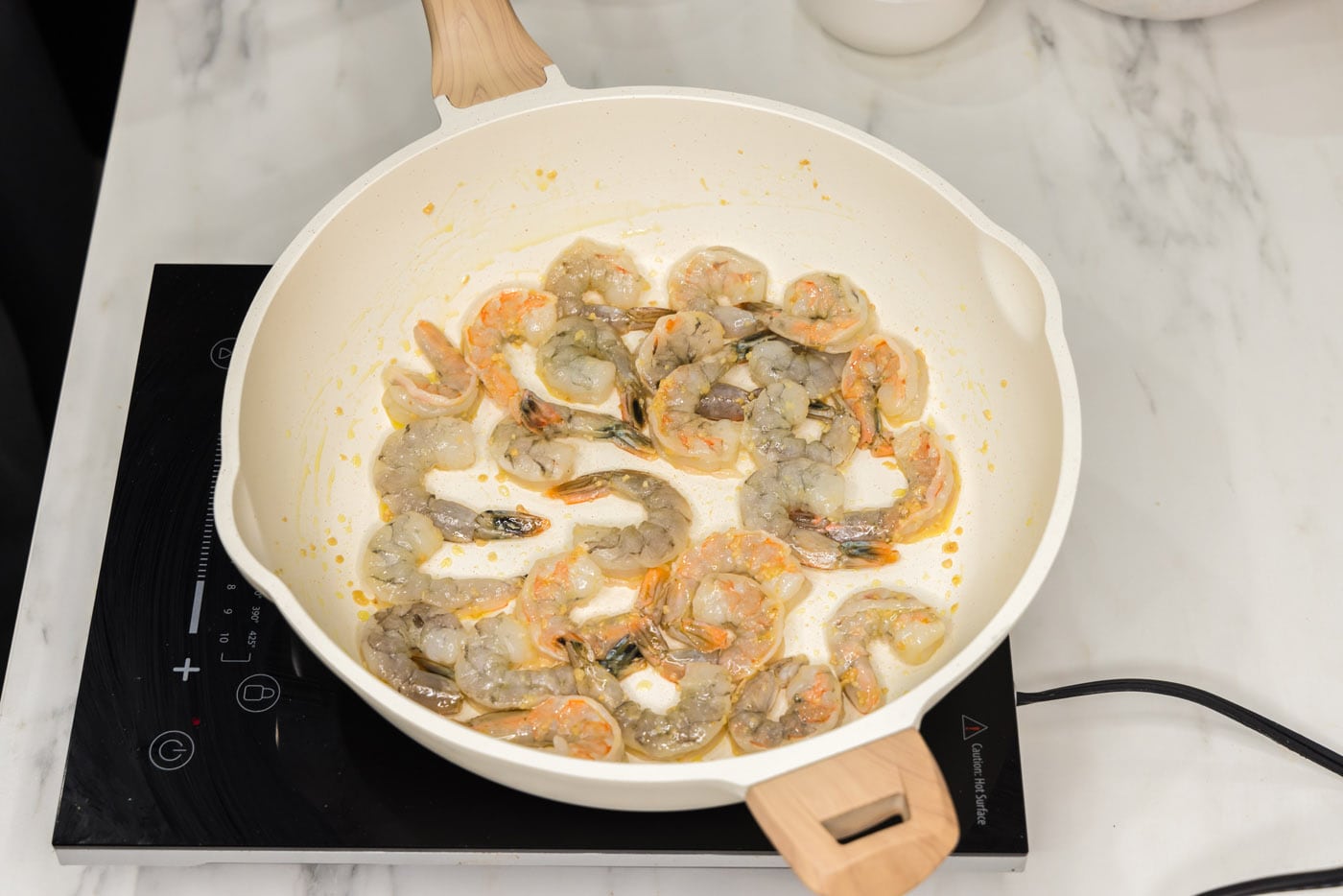 shrimp in a skillet with oil and garlic