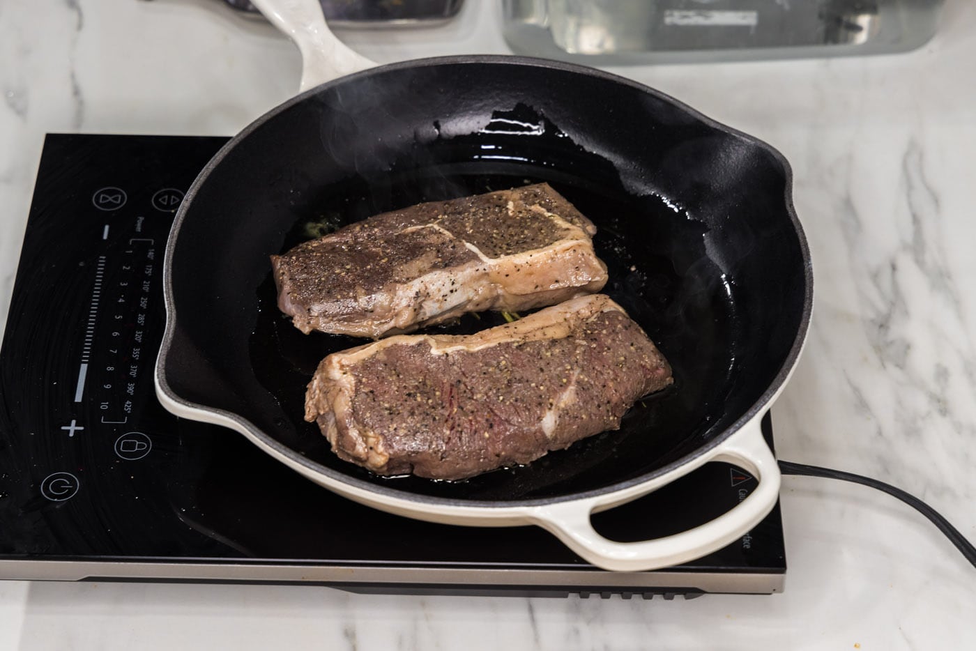 searing sous vide steaks in a skillet