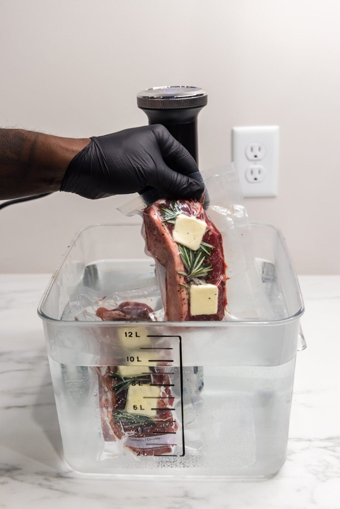 Sous Vide Steak being dropped into the Sous Vide container