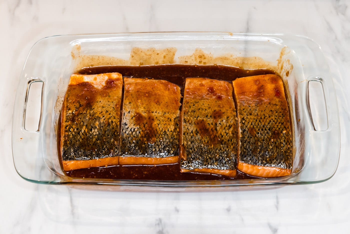 coating salmon filets in spicy marinade