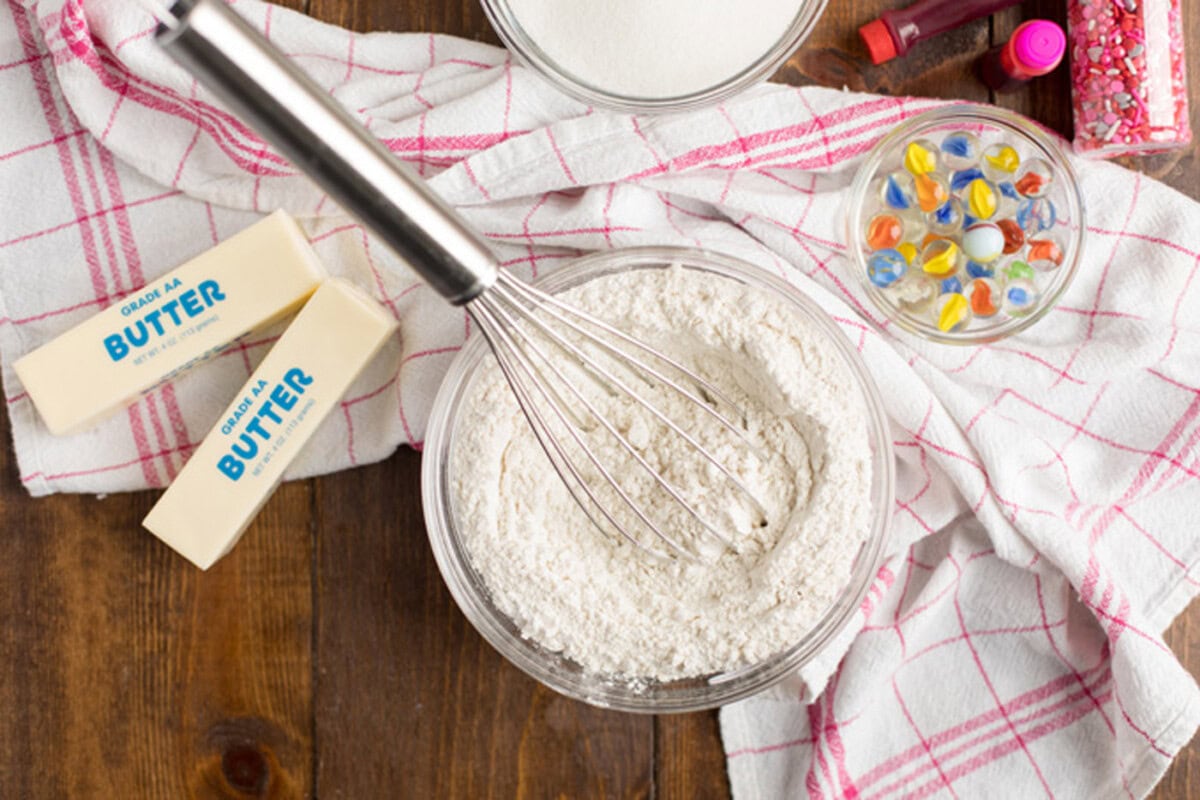 Cake flour, baking powder and salt in a bowl with a whisk