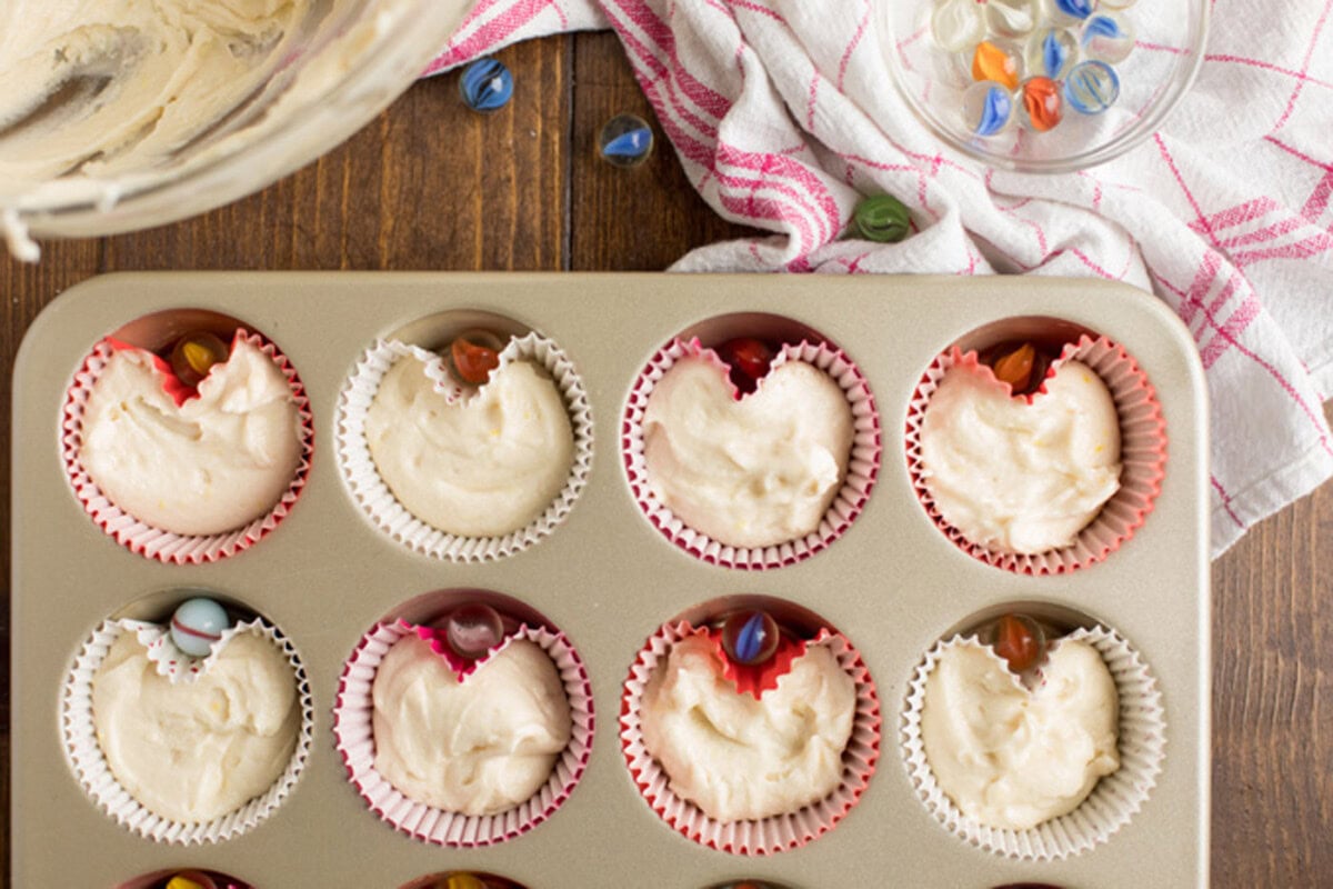 Cupcake batter in liners in a muffin pan