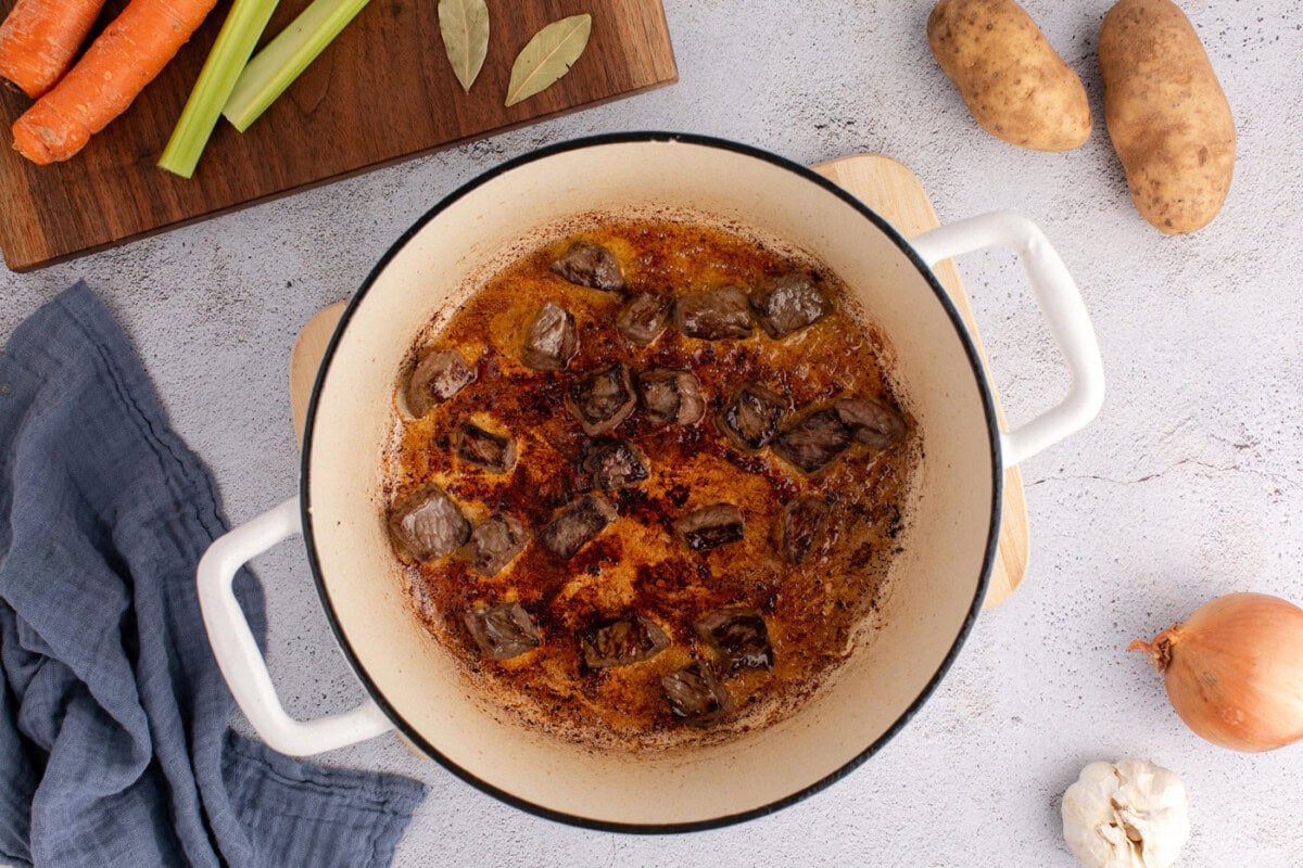 beef stewing meat browned in a dutch oven