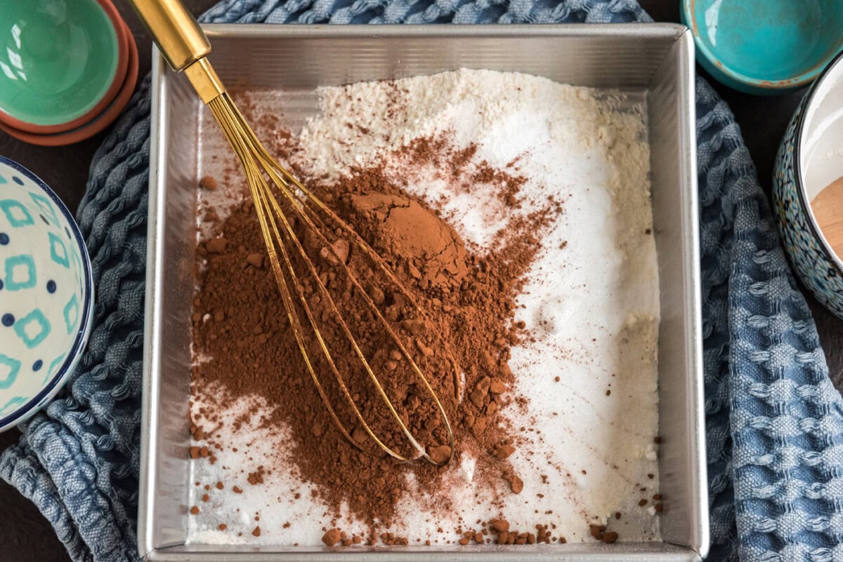 whisking cocoa powder with flour, sugar, salt, and baking powder