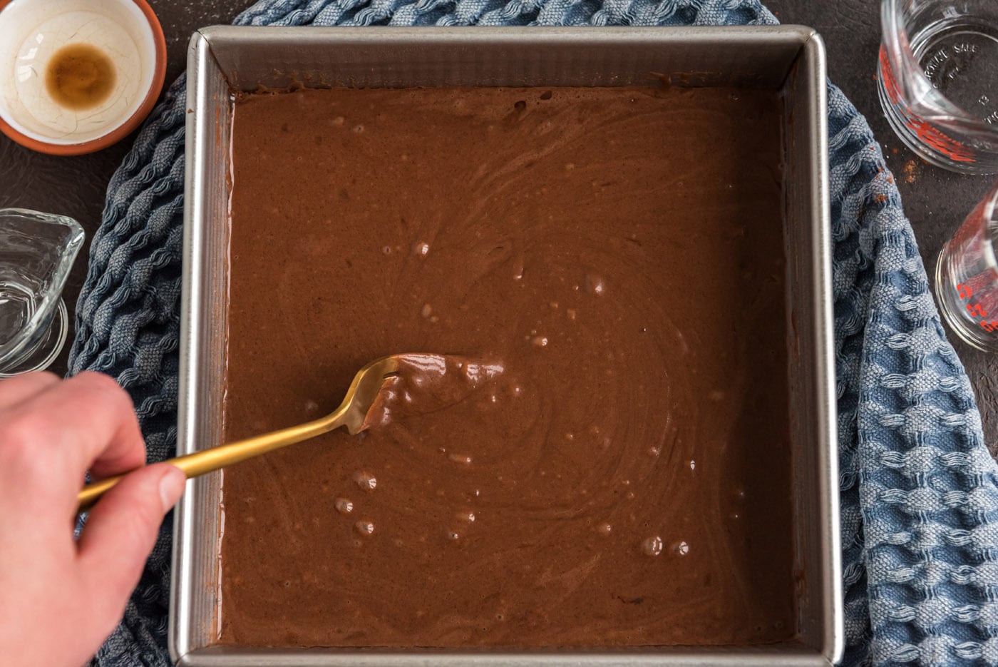 stirred chocolate cake batter in a baking dish