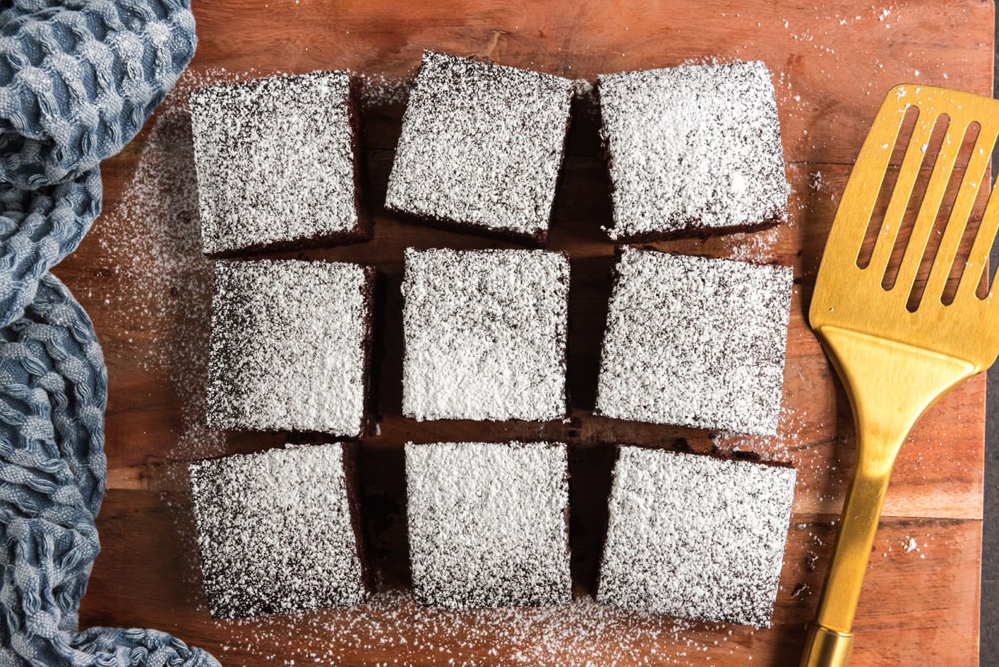 sliced wacky cake with powdered sugar topping