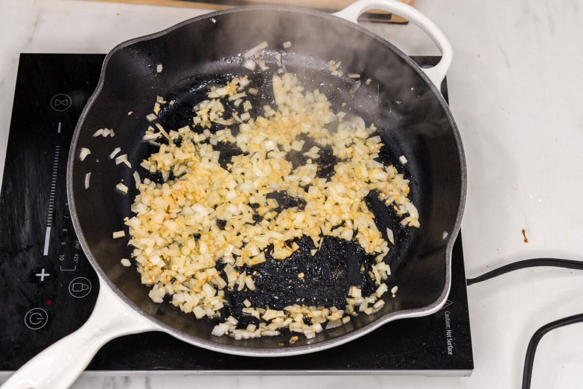 sauteeing onion and garlic in a skillet