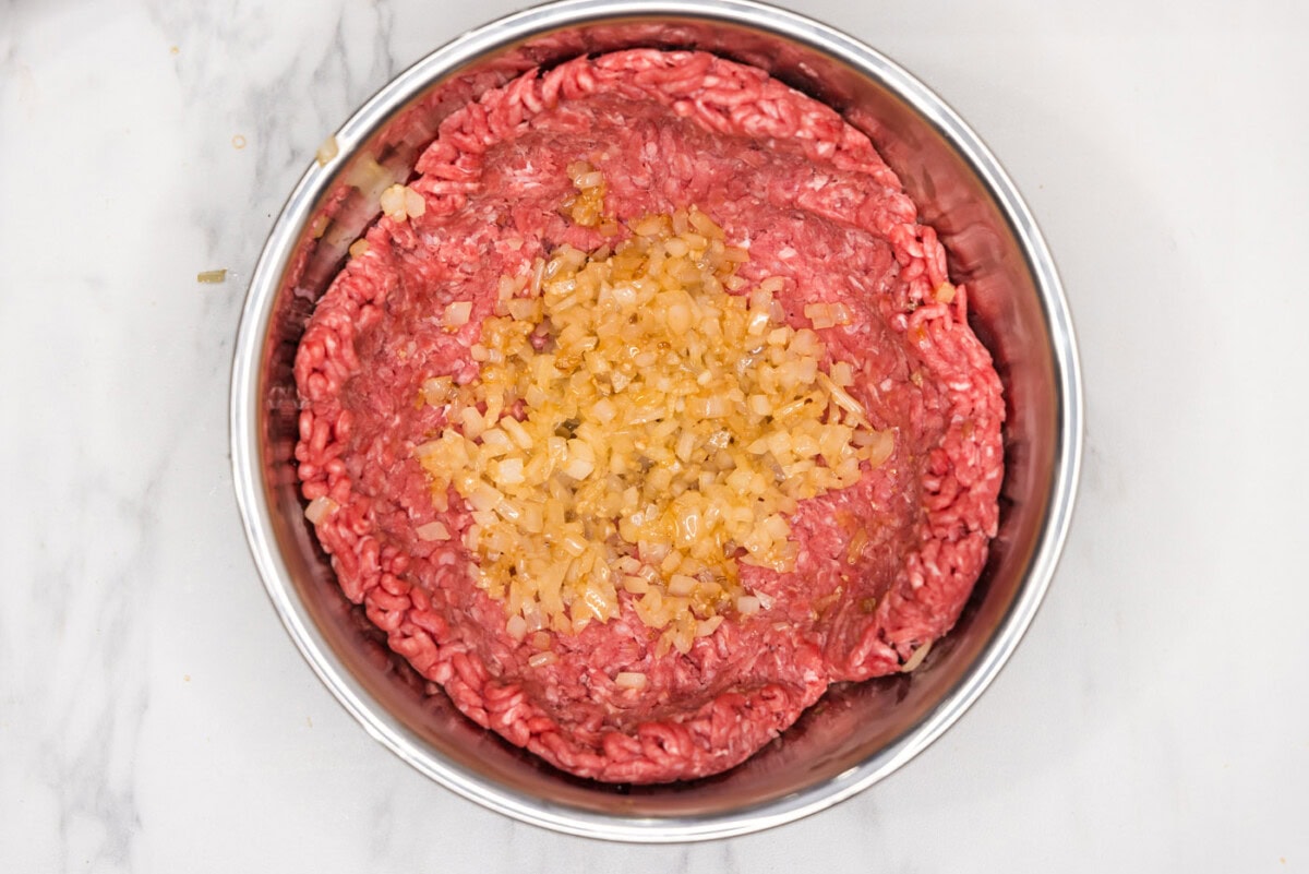 adding sauteed onion and garlic to ground beef