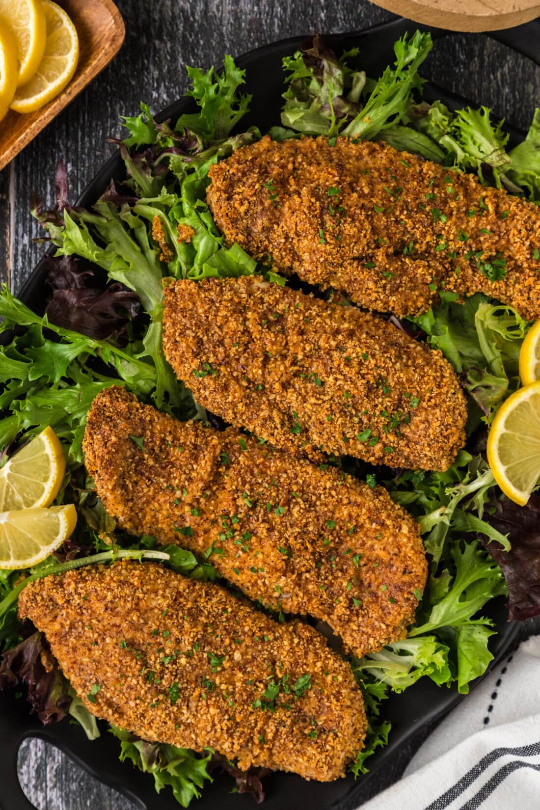 Four Almond Crusted Chicken breasts on a platter