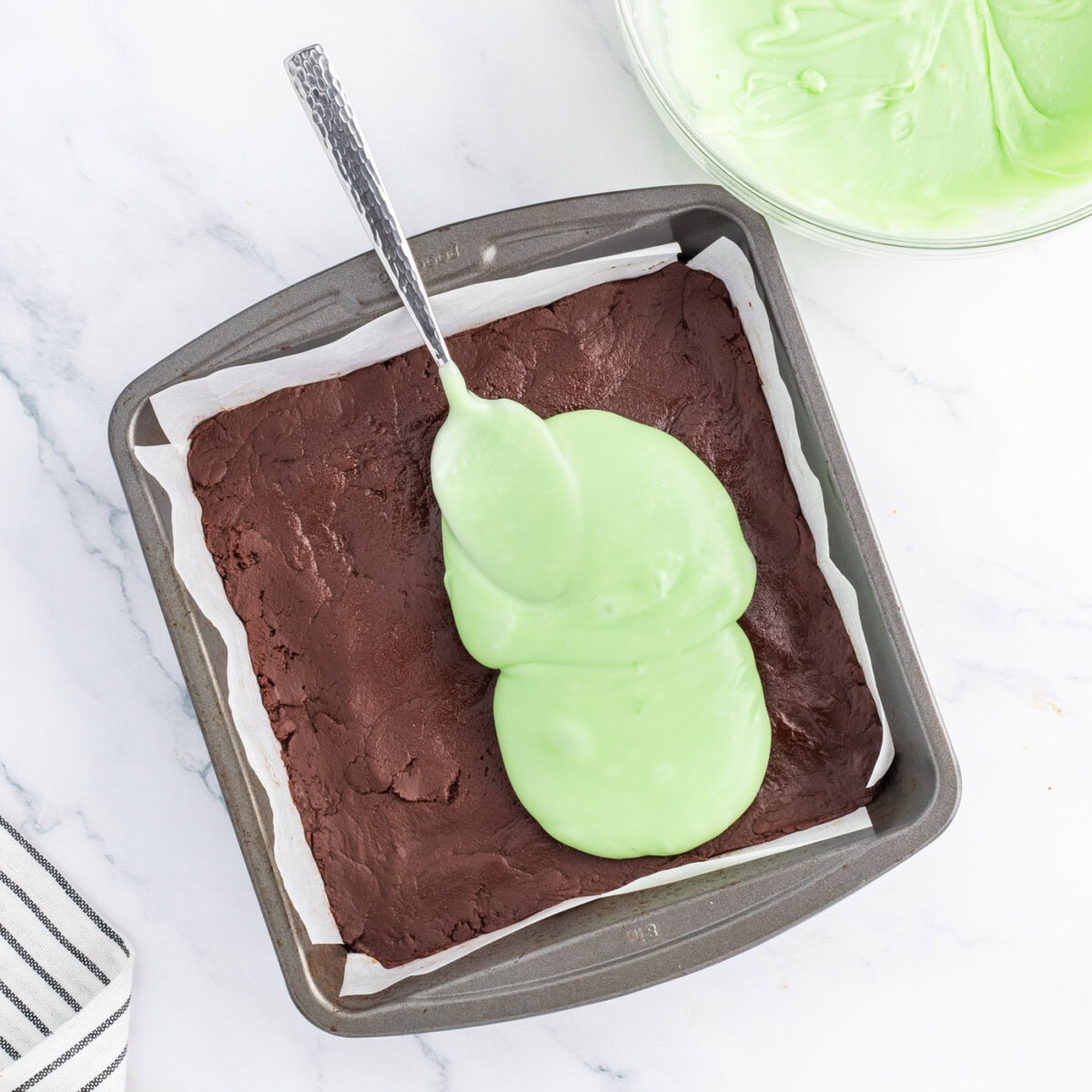 spread mint fudge mixture over chocolate fudge