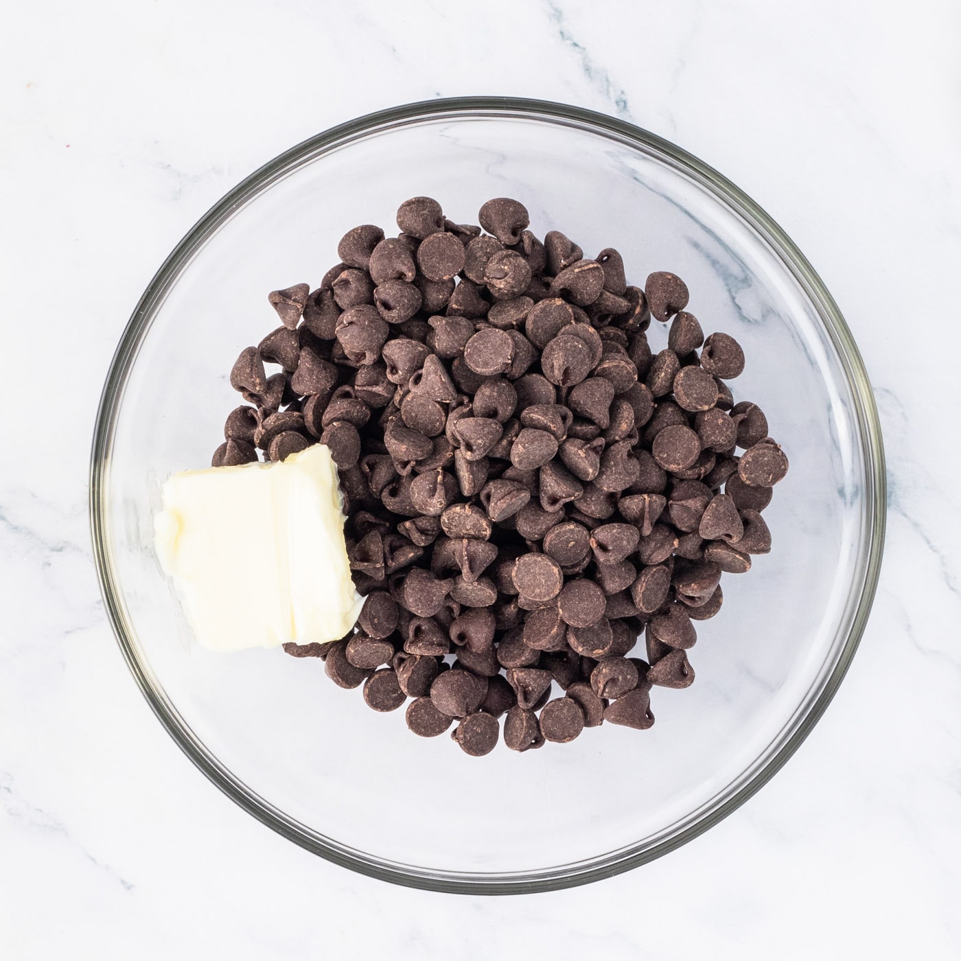 semi sweet chocolate chips in a bowl with butter