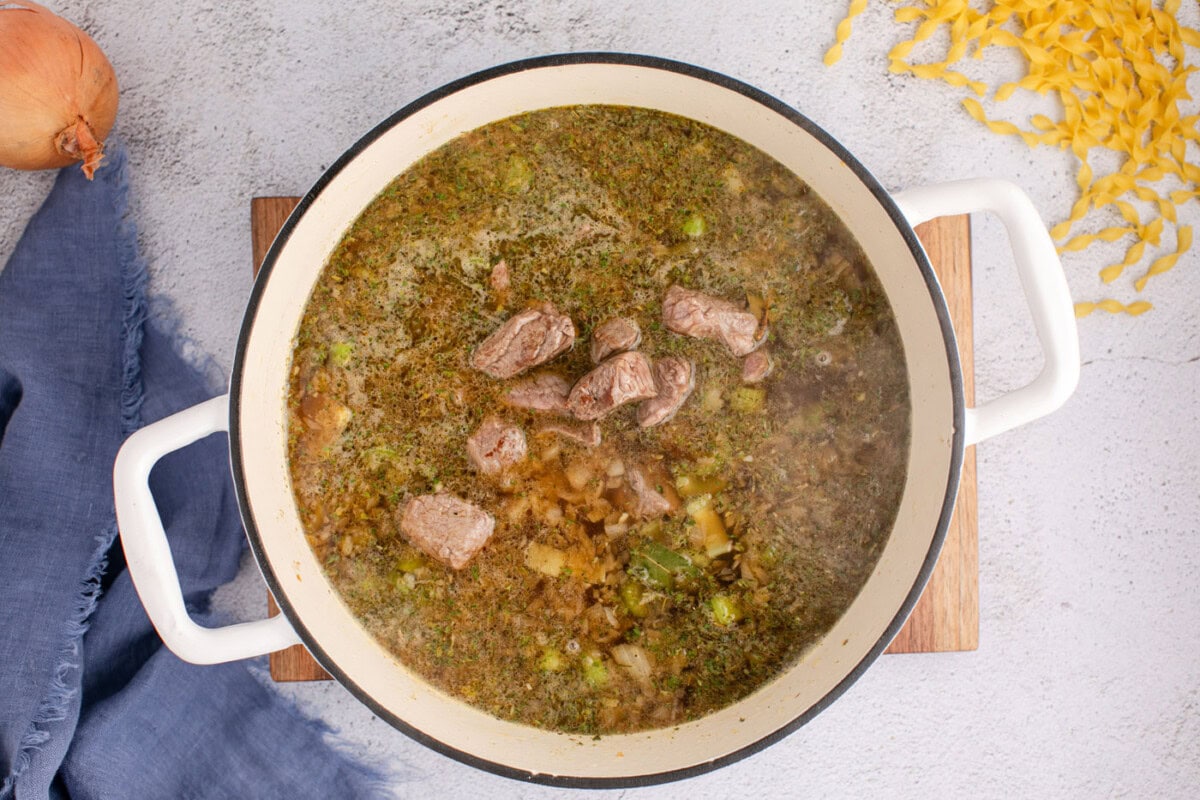 beef noodle soup simmering in a pot