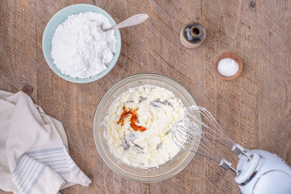 mixing vanilla with butter and cream cheese mixture
